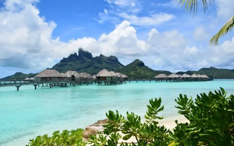 Overwater villas above turquoise lagoon in bora bora