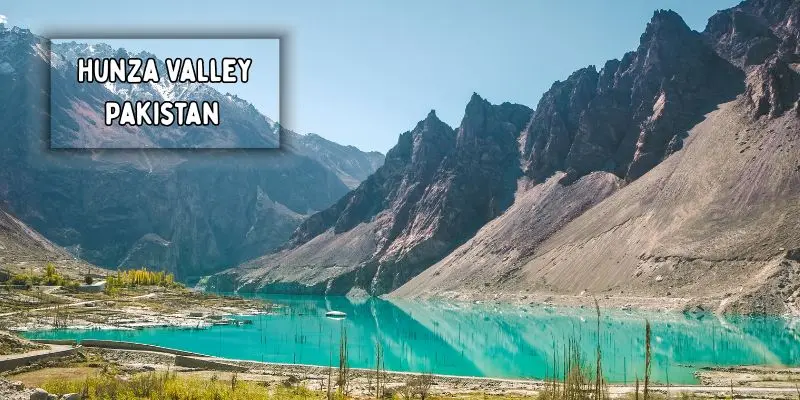 Scenic road along hunza river with towering mountains in hunza valley