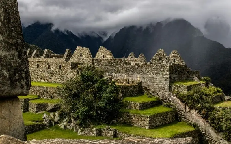 Historic machu picchu surrounded by cloud-covered peaks
