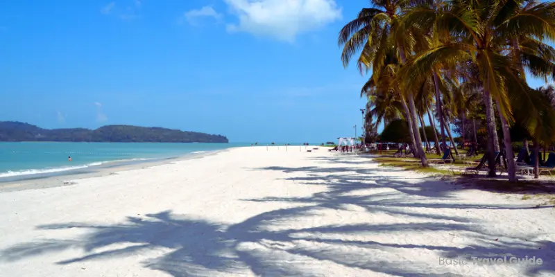 Pantai cenang in malaysia with sandy beach, palm trees, and calm sea