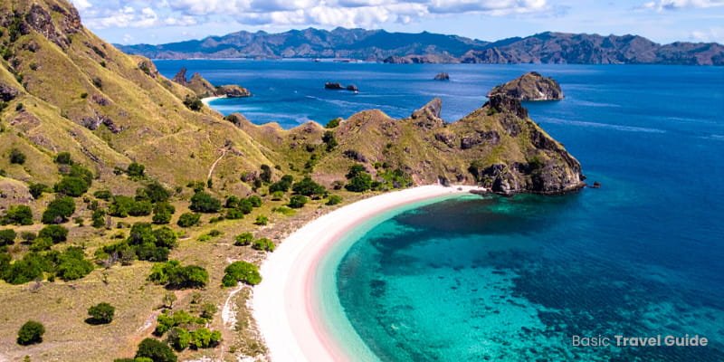 Pink beach in indonesia with soft pink sand and clear turquoise water