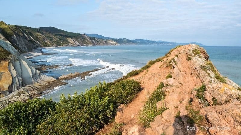 Zumaia beach in basque country, spain with dramatic flysch cliffs and ocean waves