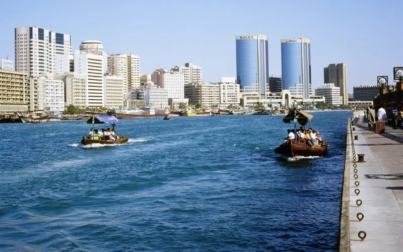 Dubai creek in dubai uae, historic waterway with wooden abras, deira and bur dubai skyline, traditional trading port area in uae 7-day itinerary