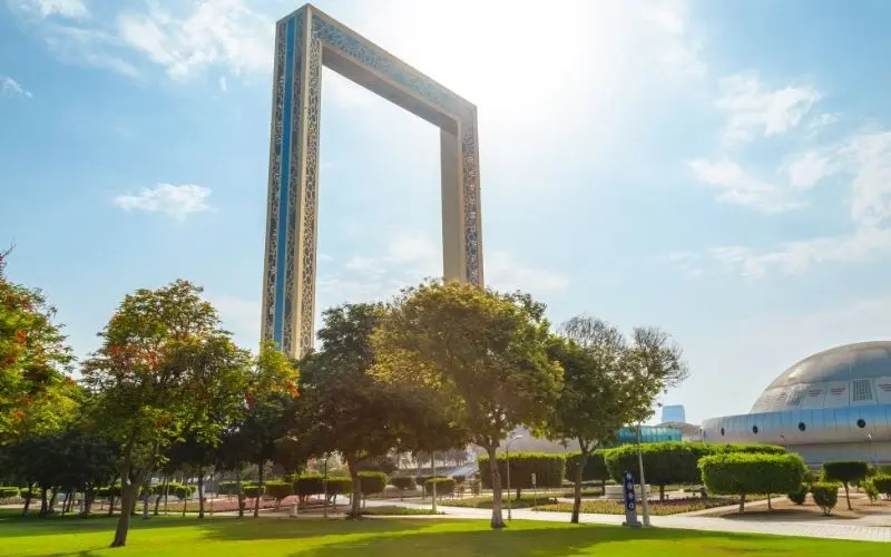 Panoramic view through dubai frame structure of old and new dubai