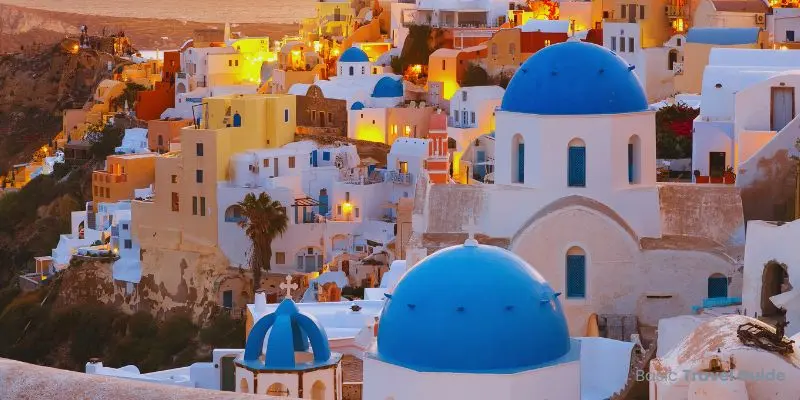 Scenic greek island with white houses, blue domes