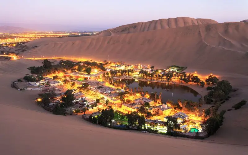 Huacachina desert oasis surrounded by sand dunes in peru