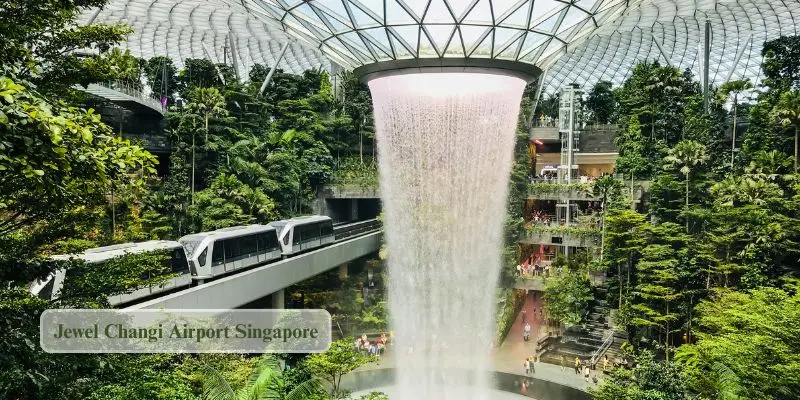 Jewel changi airport singapore indoor rain vortex waterfall surrounded by glass dome one of the best place to visit