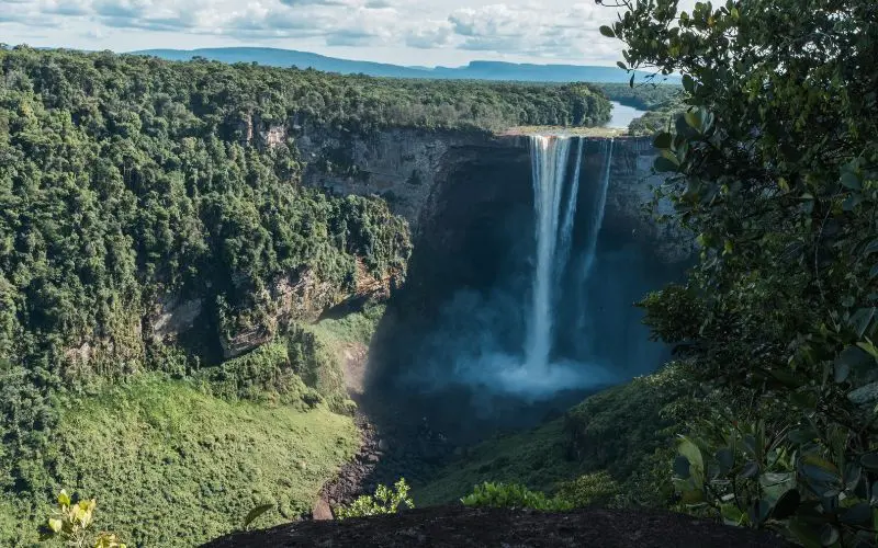 The 12 Best Countries To Visit In South America Kaieteur falls in guyana surrounded by tropical rainforest