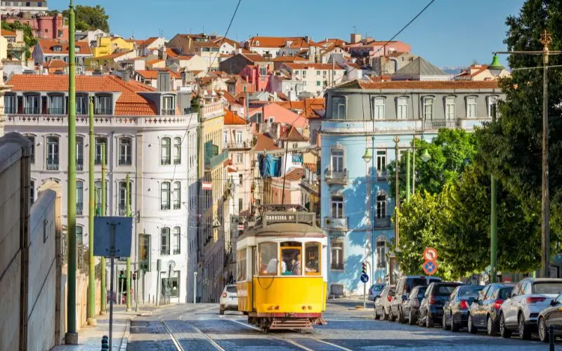 15 Most Beautiful Cities In The World You Should Visit Historic yellow tram on a street in lisbon, portugal