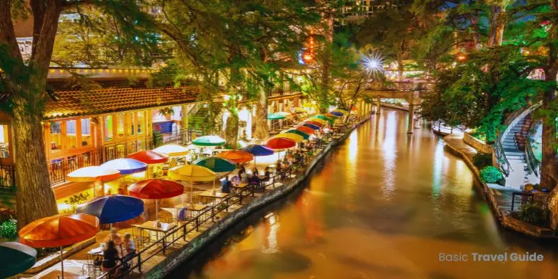 Scenic view of the river walk in san antonio, texas with restaurants and greenery