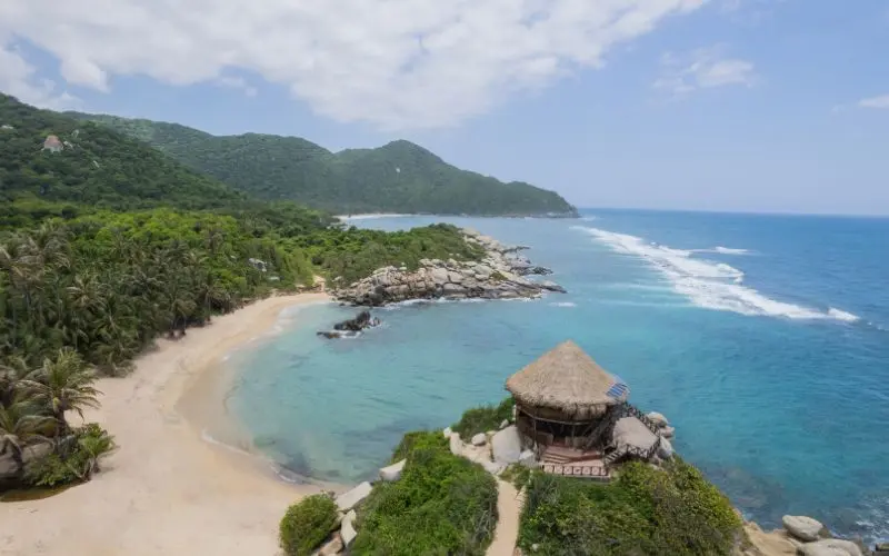 Caribbean beach surrounded by rainforest in tayrona national park