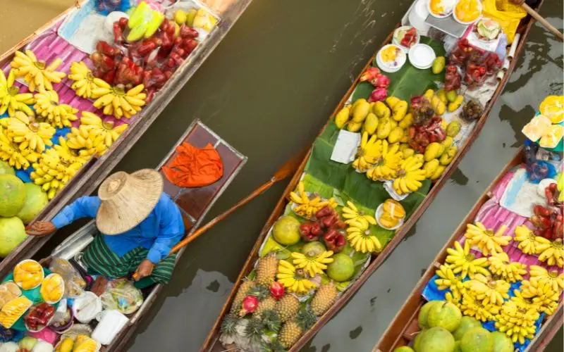 Traditional floating market in thailand with boats selling local food and goods